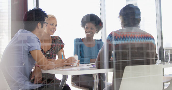 Smiling business people meeting in conference room