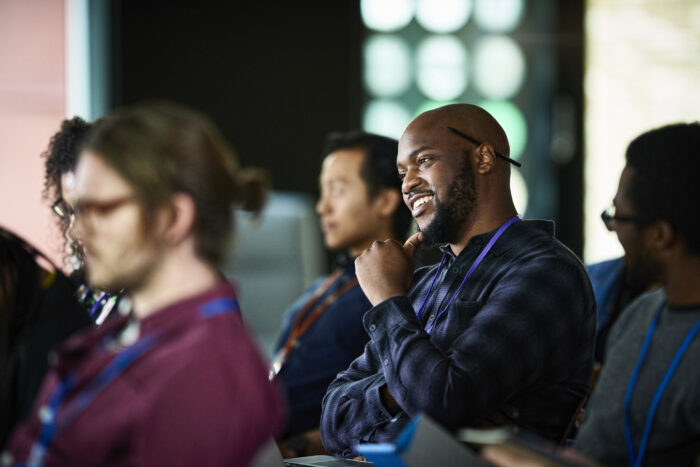 Smiling young businessman at conference