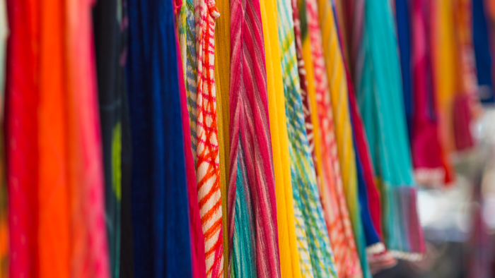 close up photograph of fabrics in various colors and textures