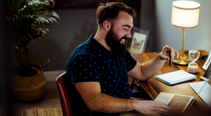 man on home computer in trendy office