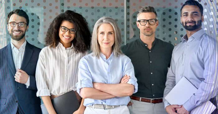 group of office coworkers facing the camera and smiling