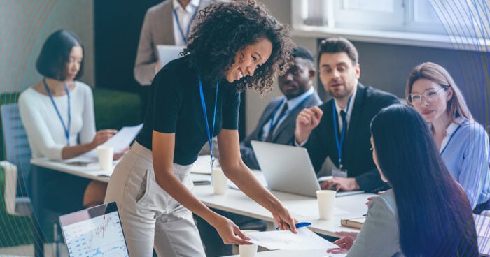 group of diverse working professionals workshopping material at a table