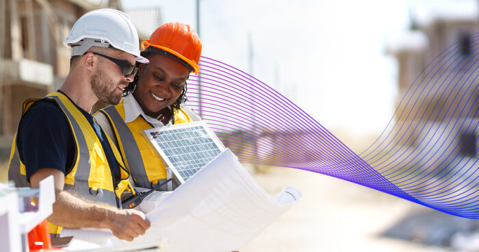 senior civil engineers inspecting or working in construction site, contractor examining a building blueprint or layout on paper.