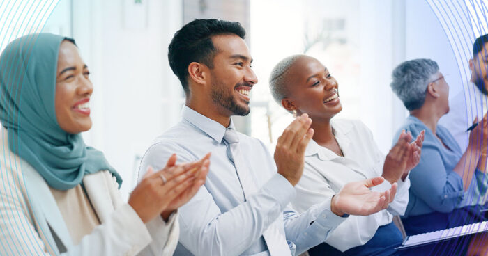 diverse group of people clapping, with a subtle blue wave effect in the background