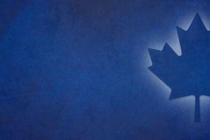 dark blue background with illuminated Canadian Maple Leaf